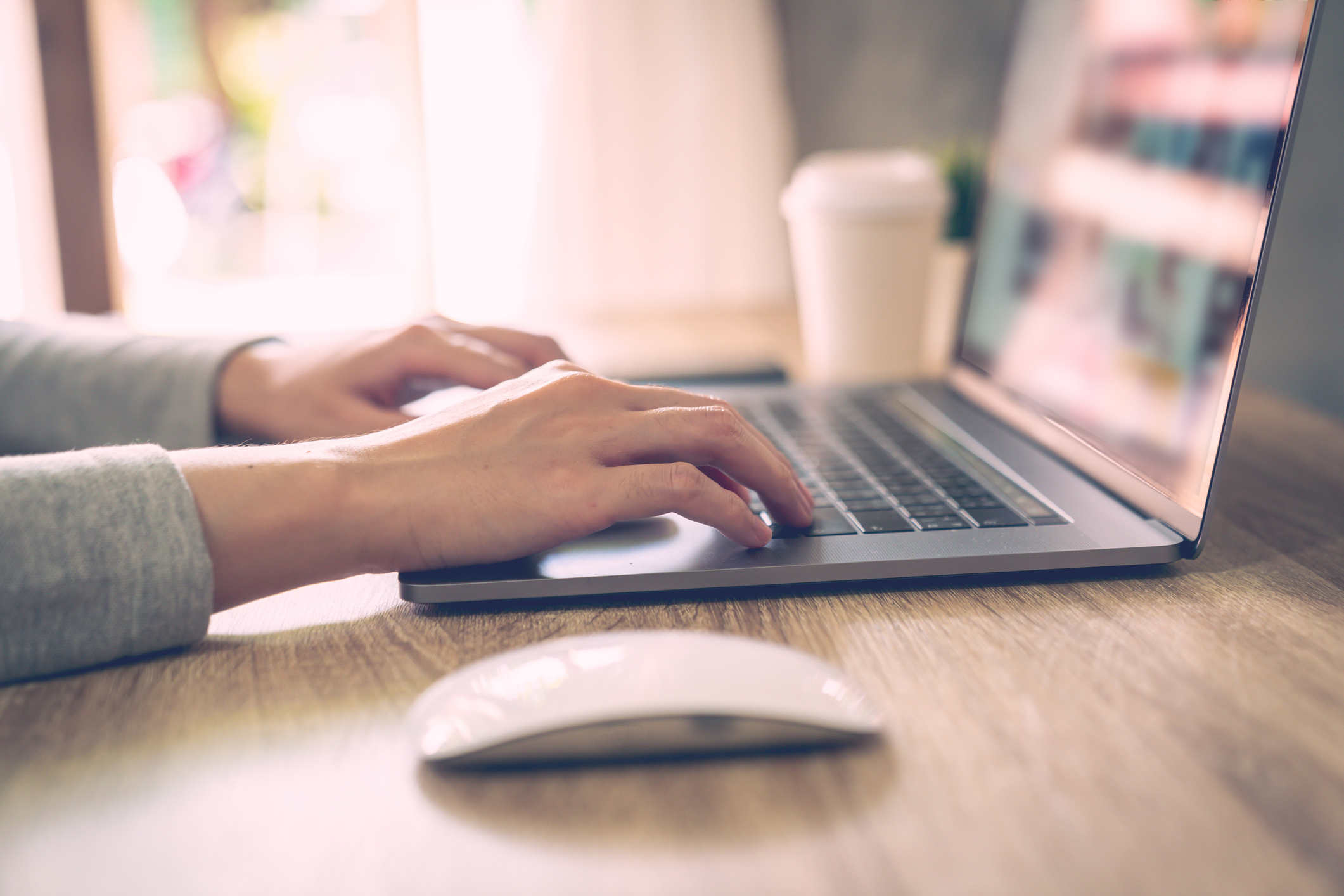 Business woman using laptop computer do online activity on wood table at home office.
